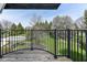 Scenic backyard view from a wood deck overlooking lush green lawn and mature trees at 14990 E 104Th St, Fishers, IN 46040
