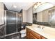 Elegant bathroom featuring a glass-enclosed shower and a wood vanity at 14990 E 104Th St, Fishers, IN 46040