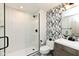 Modern bathroom with a walk-in shower and a patterned accent wall at 14990 E 104Th St, Fishers, IN 46040