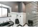 Modern bathroom features a black sink, urinal, and a black and white checkered accent wall at 14990 E 104Th St, Fishers, IN 46040