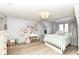 Charming bedroom featuring a floral wall design, vanity, and well-lit window at 14990 E 104Th St, Fishers, IN 46040