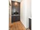 Butler's pantry with custom cabinets, built-in espresso maker, hardwood floors, and marble countertop at 14990 E 104Th St, Fishers, IN 46040
