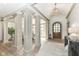 Elegant foyer featuring high ceilings, decorative columns, hardwood floors, and a wooden front door at 14990 E 104Th St, Fishers, IN 46040