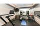 Home gym equipped with a treadmill, weights, yoga mats, and large mirror at 14990 E 104Th St, Fishers, IN 46040