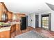 Functional kitchen with wooden cabinets, brick floors, and modern appliances at 14990 E 104Th St, Fishers, IN 46040