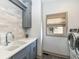 Laundry room with a sink, storage cabinets, and modern appliances at 14990 E 104Th St, Fishers, IN 46040