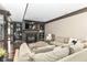 Comfortable living room features built-in shelves, a stone fireplace, and plenty of seating at 14990 E 104Th St, Fishers, IN 46040