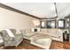 Bright and inviting living room with a large sectional sofa and dark wood floors at 14990 E 104Th St, Fishers, IN 46040