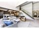 Bright living room featuring an open floor plan, hardwood floors, and a modern staircase at 14990 E 104Th St, Fishers, IN 46040