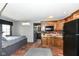 Cozy living space with kitchenette featuring wooden cabinets and brick flooring at 14990 E 104Th St, Fishers, IN 46040