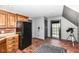 Open-concept living space featuring kitchenette, brick floors, and exterior access at 14990 E 104Th St, Fishers, IN 46040