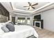 Spacious primary bedroom with a fireplace and sunroom access with lots of natural light at 14990 E 104Th St, Fishers, IN 46040