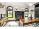 Cozy home office with a fireplace, natural light, and hardwood floors at 14990 E 104Th St, Fishers, IN 46040