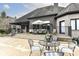 Outdoor patio with seating, dining table, grill, and manicured landscaping at 14990 E 104Th St, Fishers, IN 46040