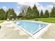 A serene rectangular in-ground pool is surrounded by lounge chairs and lush landscaping at 14990 E 104Th St, Fishers, IN 46040