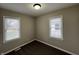 Cozy bedroom featuring neutral paint, carpet floors, and natural light from two windows at 1612 E Raymond St, Indianapolis, IN 46203
