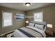 Cozy bedroom with comfortable queen-size bed, two bedside tables, and windows for natural light at 1612 E Raymond St, Indianapolis, IN 46203