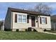 Charming home featuring a well-manicured lawn, vinyl siding, and delightful curb appeal at 1612 E Raymond St, Indianapolis, IN 46203