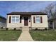 Charming home featuring a well-manicured lawn, vinyl siding, and delightful curb appeal at 1612 E Raymond St, Indianapolis, IN 46203