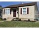 Charming home featuring a well-manicured lawn, vinyl siding, and delightful curb appeal at 1612 E Raymond St, Indianapolis, IN 46203