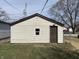 The back of the garage has a single window and door that leads to the backyard at 1612 E Raymond St, Indianapolis, IN 46203