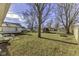 Spacious backyard with grass, trees, and patio furniture at 2117 N Glenwood Ave, Muncie, IN 47304