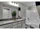 Clean bathroom with double vanity, gray cabinets, and a bathtub at 3050 Vista View Dr, Greenwood, IN 46143