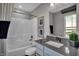 Clean bathroom with a bathtub, shower, gray vanity, and a window view at 3050 Vista View Dr, Greenwood, IN 46143