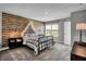 Charming bedroom with a rustic log cabin wall and a metal framed bed at 3050 Vista View Dr, Greenwood, IN 46143
