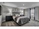 Well-lit bedroom with a gray upholstered bed and dark nightstands at 3050 Vista View Dr, Greenwood, IN 46143