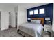 Bright bedroom with a navy accent wall and en-suite bathroom at 3050 Vista View Dr, Greenwood, IN 46143