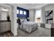 Spacious bedroom with a navy accent wall, large window and en-suite bathroom at 3050 Vista View Dr, Greenwood, IN 46143