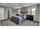 Bright bedroom with gray upholstered bed, dark nightstands, and closet at 3050 Vista View Dr, Greenwood, IN 46143