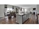 Open concept kitchen features island with seating, stainless steel appliances, and hardwood floors at 3050 Vista View Dr, Greenwood, IN 46143