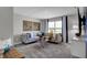Cozy living room with sectional sofa and large window overlooking the backyard at 3050 Vista View Dr, Greenwood, IN 46143