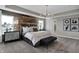 Main bedroom with large bed, wood accent wall and ensuite bath at 3050 Vista View Dr, Greenwood, IN 46143
