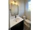 Powder room features a sleek black vanity with a white countertop and modern fixtures at 373 S Cherry St, Westfield, IN 46074