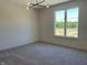 Sunlit bedroom featuring neutral walls, plush carpet, and a modern chandelier at 373 S Cherry St, Westfield, IN 46074