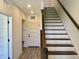 Entryway with staircase, coat closet, and LVP flooring; an inviting and practical space at 373 S Cherry St, Westfield, IN 46074