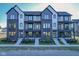Modern townhomes with brick and siding facade, black trim, and small front gardens at 373 S Cherry St, Westfield, IN 46074