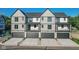 Townhome exterior featuring gray siding, black trim, and individual garages with driveway at 373 S Cherry St, Westfield, IN 46074