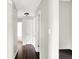 Clean and well-maintained hallway featuring neutral paint, dark hardwood floors, and multiple doorways at 5327 Milhouse Rd, Indianapolis, IN 46221