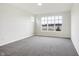 Spacious bedroom with large window and grey carpet at 7159 Rose Hill Ave, Brownsburg, IN 46112