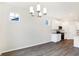 Bright dining room features chandelier and hardwood floors at 7159 Rose Hill Ave, Brownsburg, IN 46112