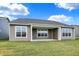 Rear view of house showcasing patio and landscaping at 7159 Rose Hill Ave, Brownsburg, IN 46112