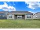 Rear view of house showcasing patio and landscaping at 7159 Rose Hill Ave, Brownsburg, IN 46112