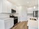 Modern kitchen with white cabinets, stainless steel appliances and island at 7159 Rose Hill Ave, Brownsburg, IN 46112