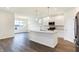 Modern kitchen with white cabinets, stainless steel appliances and large island at 7159 Rose Hill Ave, Brownsburg, IN 46112