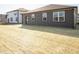 Back of home showcasing a large yard, dark siding, and well-placed windows at 9236 Kavanaugh Dr, Indianapolis, IN 46239
