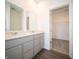 Bathroom with double sinks, granite countertops, and access to a walk-in closet at 9236 Kavanaugh Dr, Indianapolis, IN 46239